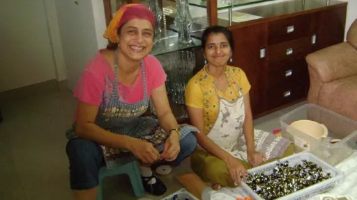 Nita with Deepa with chocolates in front of them